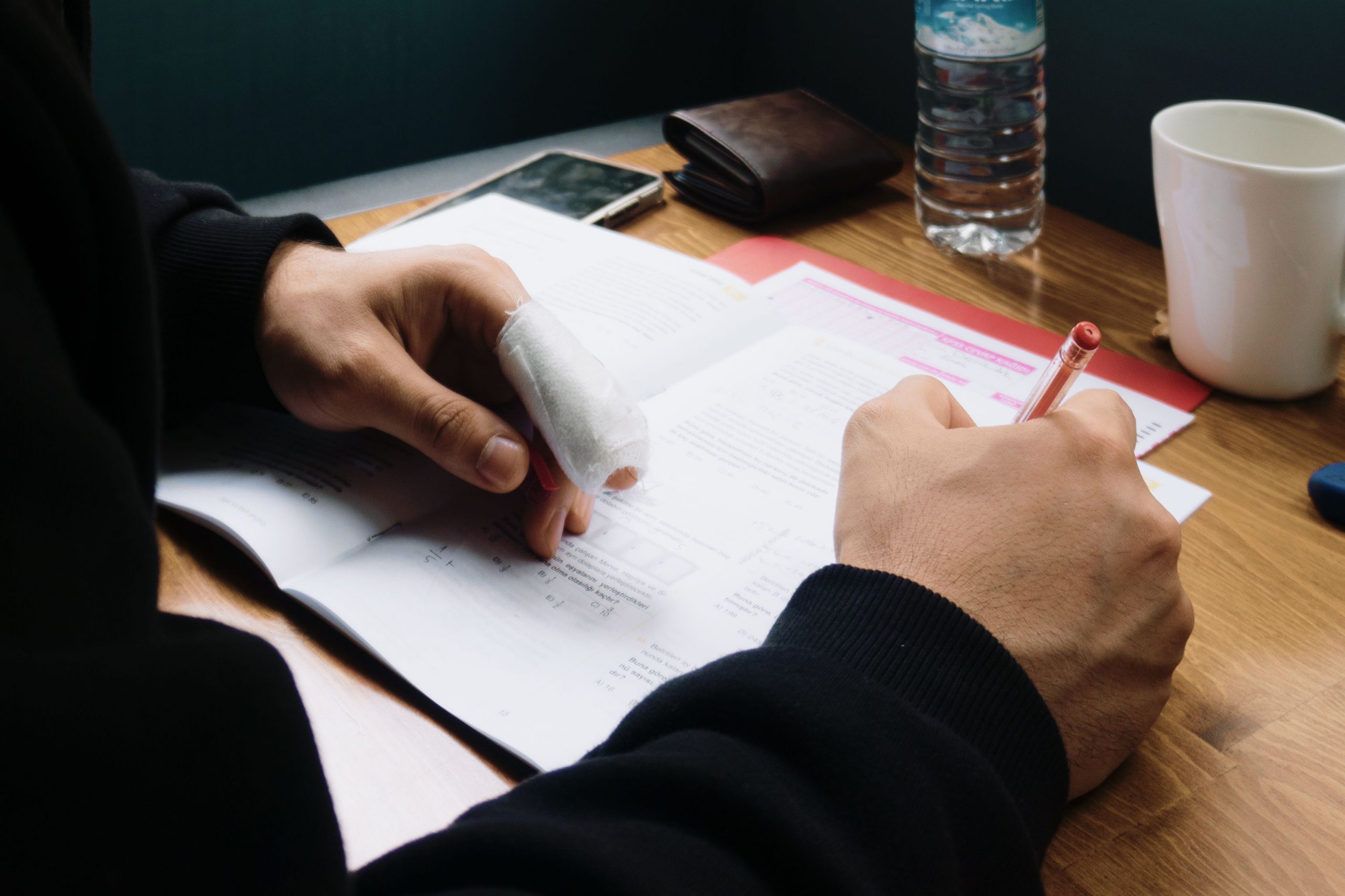 man with an injured finger signing a document
